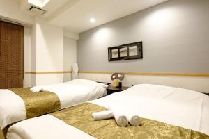 Postel nebo postele na pokoji v ubytování 東京新橋579 Shinbashi Residence