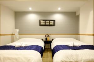 Postel nebo postele na pokoji v ubytování 東京新橋579 Shinbashi Residence