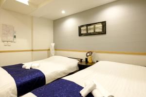Postel nebo postele na pokoji v ubytování 東京新橋579 Shinbashi Residence