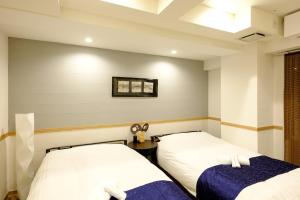 Postel nebo postele na pokoji v ubytování 東京新橋579 Shinbashi Residence