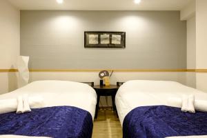 Postel nebo postele na pokoji v ubytování 東京新橋579 Shinbashi Residence