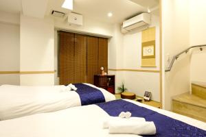 Postel nebo postele na pokoji v ubytování 東京新橋579 Shinbashi Residence