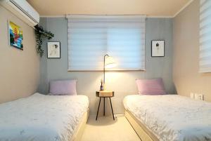 Postel nebo postele na pokoji v ubytování Riahouse KINTEX 1min 2room