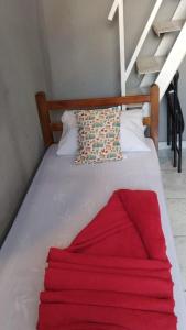 a bed with a red blanket on top of it at Hostel Aprisco São Paulo in São Paulo +23 photos