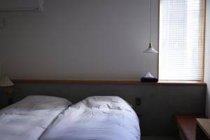 Postelja oz. postelje v sobi nastanitve Lemonsea Onomichi