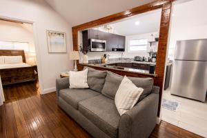 a living room with a couch and a kitchen at The Caroline Suite in Key West