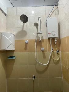 a shower in a bathroom with a shower head at Homestay Rumah Kayu Kota Tinggi in Johor Bahru