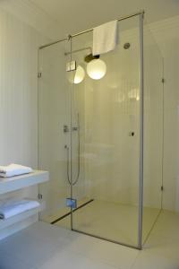 a shower with a glass door in a bathroom at Baltica Residence in Sopot