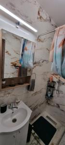 a bathroom with a sink and a mirror at Roca Room in Atias +37 photos
