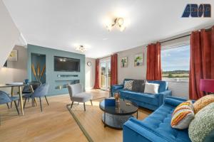 a living room with a blue couch and a table at Mount Pleasant Haven in Leslie