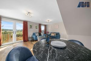 a living room with a black table and chairs at Mount Pleasant Haven in Leslie