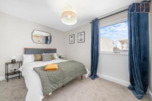 a bedroom with a bed and a large window at Mount Pleasant Haven in Leslie