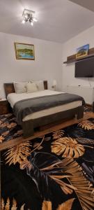 a bedroom with a large bed with a rug at Roca Room in Atias