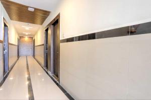un corridoio con pareti bianche e una porta di Hotel O Sarai by Som a Indore