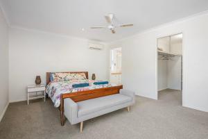 a bedroom with a bed and a ceiling fan at Noojee 27 Ballina Crescent in Port Macquarie +24 photos
