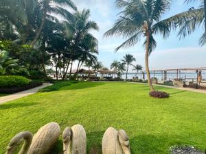 a park with a view of the ocean and palm trees at DangaBay 2R 4pax with Balcony Seaview near CIQ by Wehome in Johor Bahru