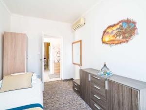 a bedroom with a bed and a dresser at Apartments Bla evi - Comfort Two Bedroom Apt with Hot Tub and Sea View in Mlini