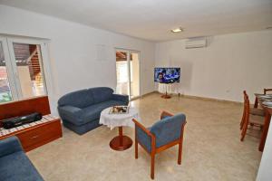 a living room with a couch and a table at Apartment with terrace and garden in Vela Luka