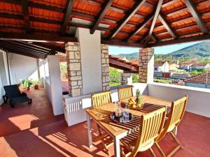 a patio with a table and chairs on a balcony at Apartment with terrace and garden in Vela Luka