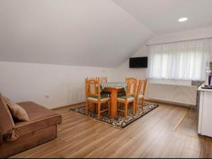 a living room with a table and chairs and a couch at Apartment Josipa- Two-Bedroom Apartment in Rakovica