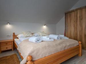 a bedroom with a bed with towels on it at Apartment Josipa- Two-Bedroom Apartment in Rakovica