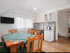 a kitchen and dining room with a table and chairs at Apartment Josipa- Two-Bedroom Apartment in Rakovica