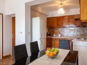 a kitchen with a table with a bowl of fruit on it at Apartments Nena ST - One Bedroom Apartment with Terrace and Sea View A4 in Pisak