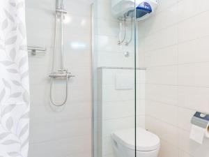 a bathroom with a toilet and a glass shower at Apartment Karlo - Two Bedroom Apartment with Balcony Matani in Kaštela +14 photos