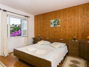 a bedroom with a large bed and a window at Apartments Maria Kolo ep- Three Bedroom Apartment with Backyard Terrace and Sea View in Koločep
