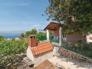 una casa con balcón y chimenea de ladrillo en Holiday Home Blossom - Four Bedroom Holiday Home with Outdoor Pool and Jacuzzi - ST, en Supetar