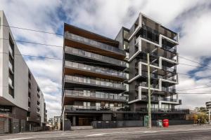 an apartment building on the corner of a street at Trendy New York-Style Condo in Vibrant St Kilda in Melbourne