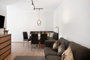 a living room with a couch and a table with chairs at Allpano in Dietmannsried