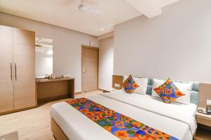 a hotel room with two beds and a kitchen at FabHotel Sivalika Inn - Howrah in Kolkata