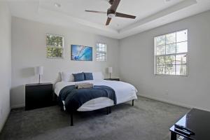 a white bedroom with a bed and a ceiling fan at Fun In The Sun 2 Bed 2 Bath Home in Oceanside