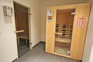 a room with two wooden doors in a room at Appartements Tamino by Schladming-Appartements in Schladming +18 photos