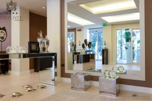 una habitación llena de muchos artículos de cristal expuestos en Hotel Kent, en Milano Marittima