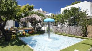 a swimming pool with a fountain in a yard at Lakki Village in Aegiali