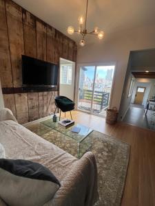 a living room with a couch and a glass table at Charming 2BR Cottage with Bay and City Views-Gated Luxury Private Place in San Francisco