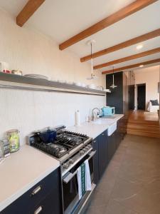 a kitchen with a stove and a counter top at Charming 2BR Cottage with Bay and City Views-Gated Luxury Private Place in San Francisco