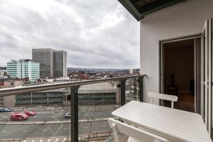 a balcony with a table and a view of a city at Roomspace Serviced Apartments - Vertex House in Croydon