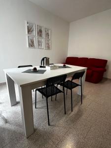 a white table with chairs and a red couch at Civico 56 in Verona +21 photos