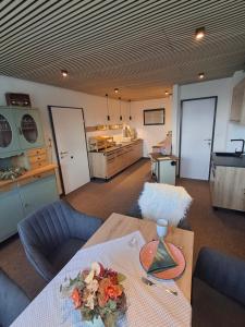 a living room with a table and a kitchen at Appartementhaus Meyer in Annaberg