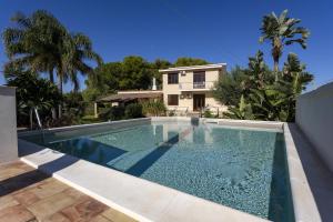 a swimming pool in front of a house at Villa Stella in Marsala