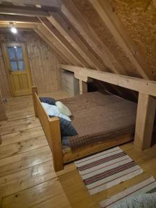 an attic room with a bunk bed in the attic at PETRA kuća za odmor in Vrbica