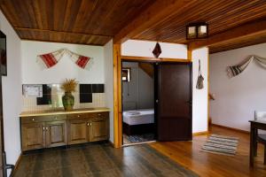 a bathroom with a wooden door and a sink at Domeniul Roa in Avrig