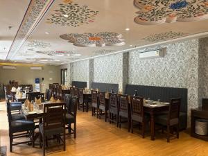 a dining room with tables and chairs and plates on the ceilings at Turban Roopgarh Resort and Spa, Udaipur in Udaipur