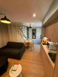 a living room with a couch and a dining room at The Duplex spa Paris in Bagnolet