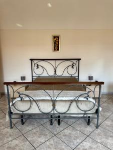 a metal bed in a room with a table at Il Terrazzino in Casale Monferrato +11 photos