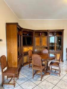 a dining room with a wooden table and chairs at Il Terrazzino in Casale Monferrato