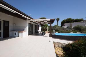 a patio of a house with a swimming pool at Villa delle Muse in Marsala +20 photos